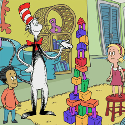 An animated scene with two children and a comic animal wearing a red and white hat looking at building blocks